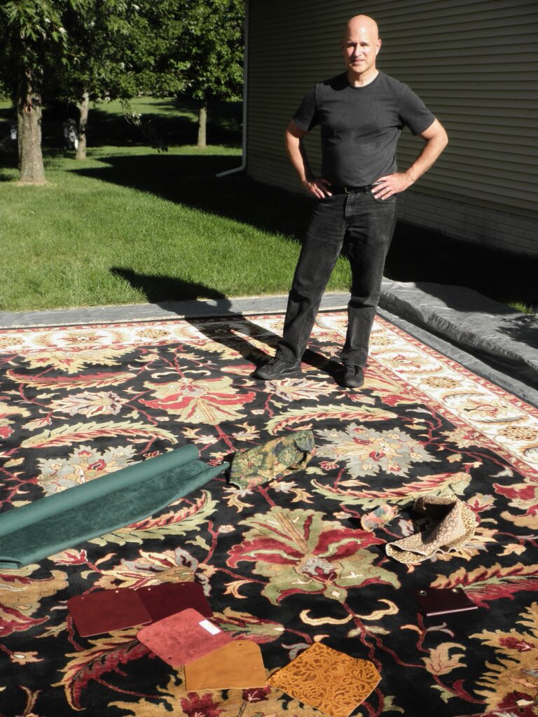 Interior Designer Steven C. Adamko standing on a hand-knotted oriental rug